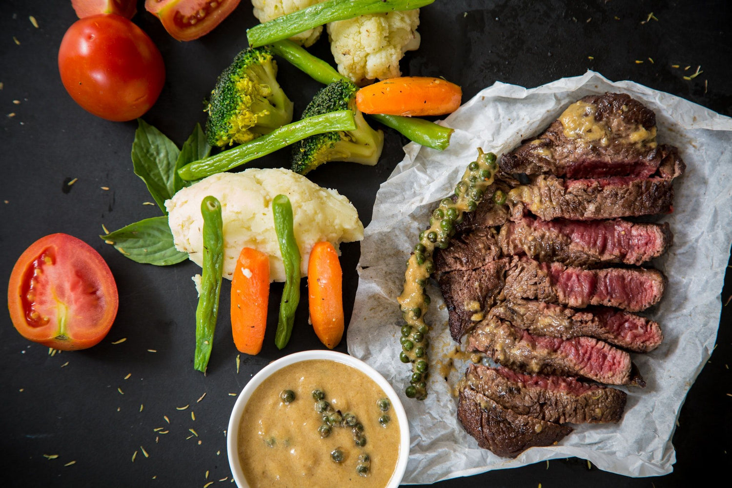 Cooked steak with carrots, asparagus, and sauce