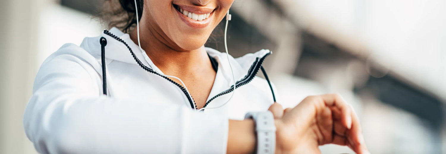 woman smiling and starting workout on watch