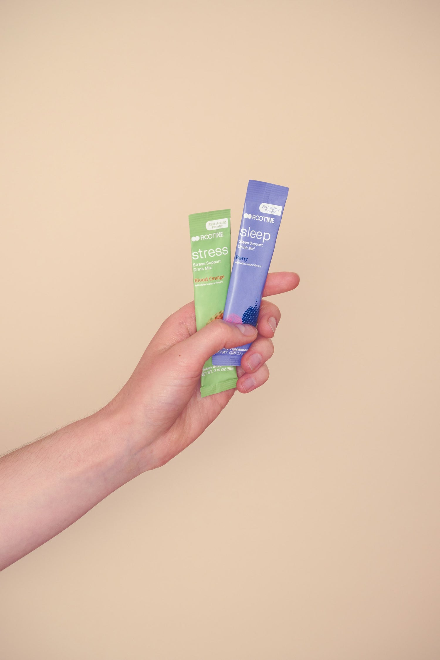 Rootine's Stress and Sleep stick packs held in hand